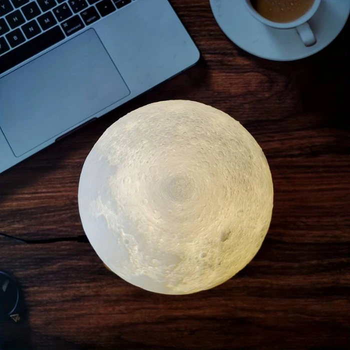 Levitating Moon in front of laptop