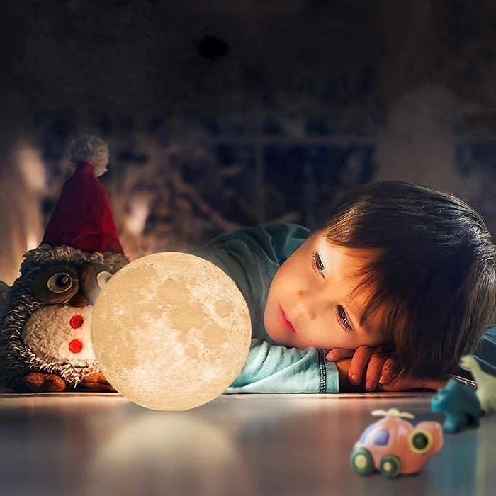 kid looking at Levitating Moon