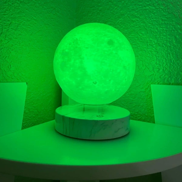 green Levitating Moon products on desk